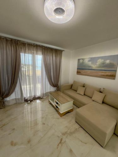 a living room with a couch and a table at Filocsenia luxury suite in Tsoutsouros