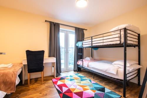 a bedroom with bunk beds and a desk and a table at Apartment with free P for Van. in Southampton