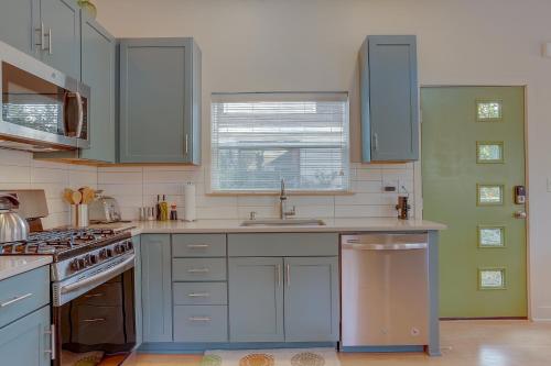 a kitchen with blue cabinets and a sink at Mod Pod in Bend
