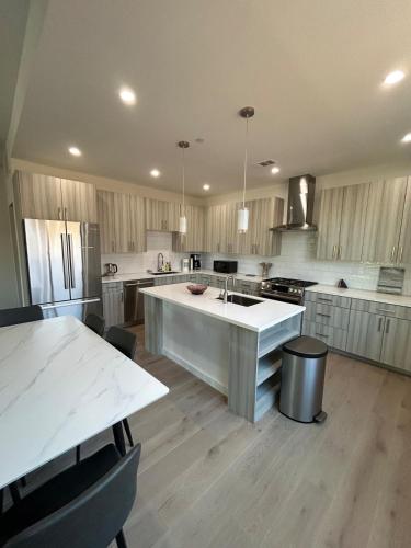 a large kitchen with a large island in the middle at 912 Brand New Spacious Tonwhome 3br 3ba sleeps 9 in Redwood City