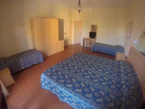 a bedroom with a bed and two couches at Hotel Riviera in Alghero