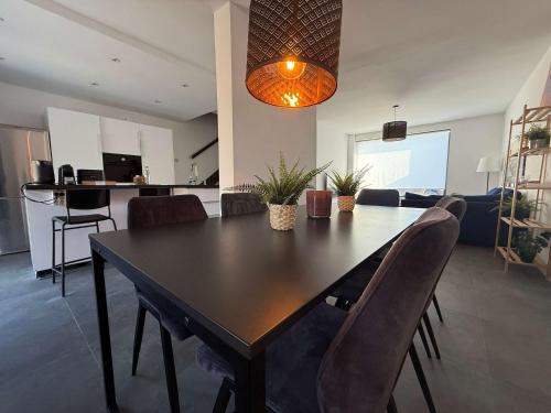 a dining table and chairs in a living room at Modern 3BR House in Central Nuenen in Nuenen