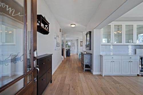 a kitchen with white cabinets and a wooden floor at Flagline Trail in Bend