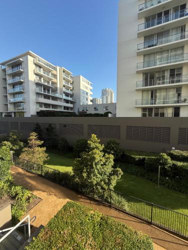 a park in front of a building with buildings at Cozy Private Room With Bathroom Right In Wollongong in Wollongong