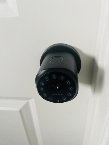 a black door lock on a white door at Edith Gate Luxe Bedroom 2 Homestay in Calgary