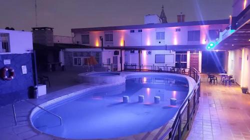 a large swimming pool in front of a building at Hotel Nuevo Enzo in Villa Carlos Paz