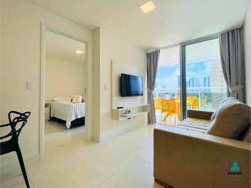 a living room with a couch and a bed and a television at Aquarius Style by Holiday Stays in Fortaleza