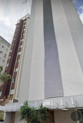 a tall building with a tie on the side of it at Loft Centro de Florianópolis apart inteiro in Florianópolis