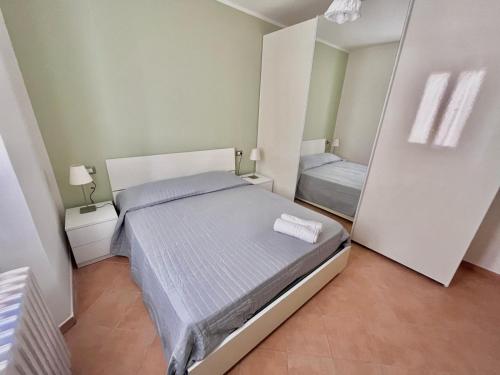 a small bedroom with a bed and a mirror at La Casa di Agnese in San Benedetto Val di Sambro