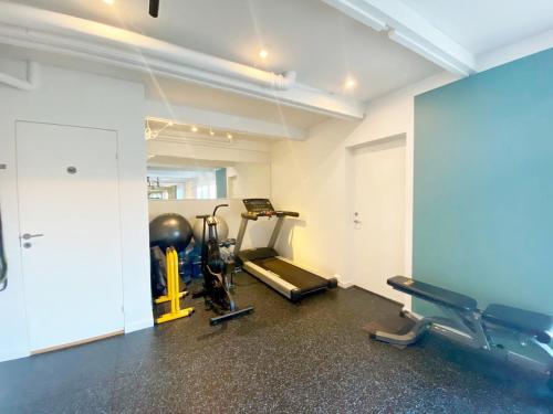 a gym with two exercise bikes and a treadmill at Villa Kristiania in Oslo
