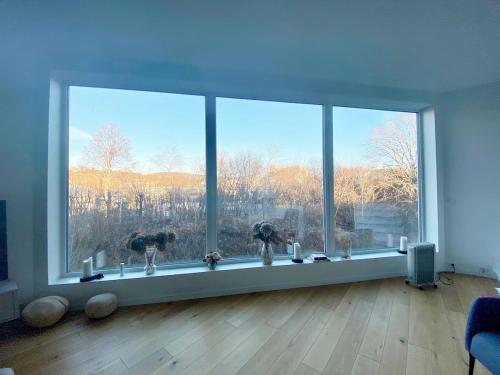 a living room with a large window with a view at Villa Kristiania in Oslo