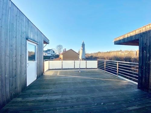 a wooden boardwalk leading to a building with a door at Villa Kristiania in Oslo