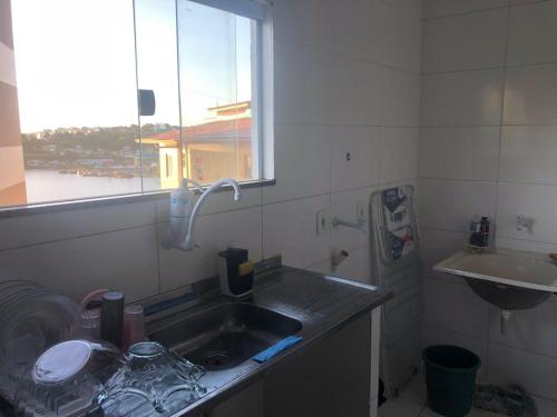 a kitchen with a sink and a window at Apto de tuco in Ilhéus