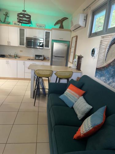 a living room with a couch and a kitchen at MY DREAM BEACH HOUSE in Aguada