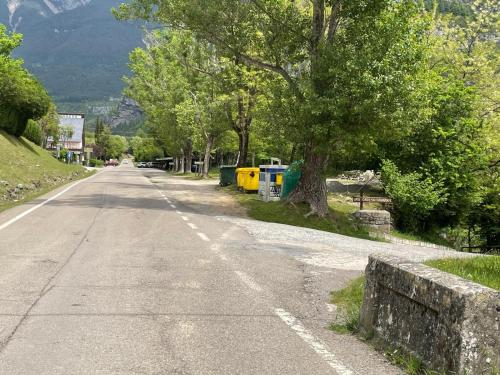 an empty road with trees on the side of the road at Apartamento Bujaruelo in Torla