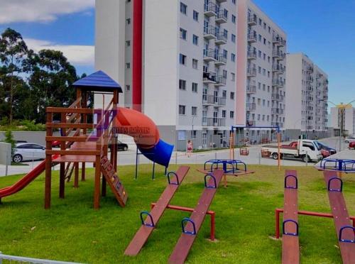a playground with a slide in a park at Ap 50m do Mar, no Coração da Praia de Fora in Palhoça