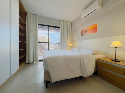 En eller flere senge i et værelse på Apto Ibiza Praia & Piscina - Conforto e Estilo