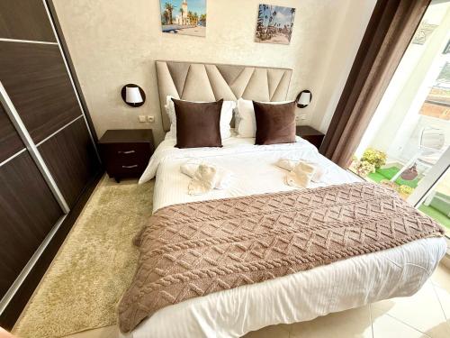 a bedroom with a large bed with two dogs on it at The Paradise of ACHAKAR in Tangier