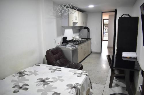a kitchen with a table and a chair in a room at San Luis Apartamento 101 Cúcuta in Cúcuta