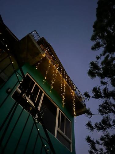 a house with christmas lights on the side of it at The Local Experience - Kalbas Suite in Choiseul