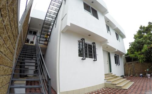 eine Treppe, die zu einem weißen Gebäude führt in der Unterkunft Departamento Rosedal 1 in Oaxtepec