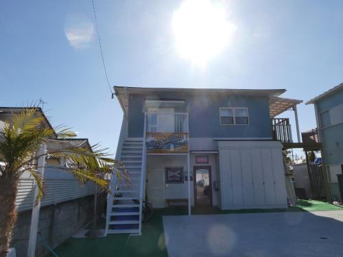 a house with a stairway leading up to it at blue dot aoshima beach house - Vacation STAY 15358 in Miyazaki