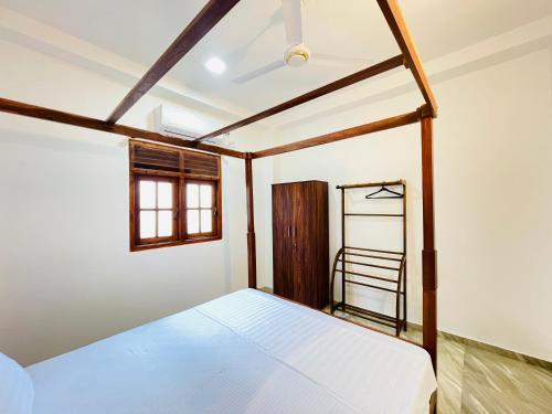 a bedroom with a bed and a ladder at Villa 10 Weligama in Weligama