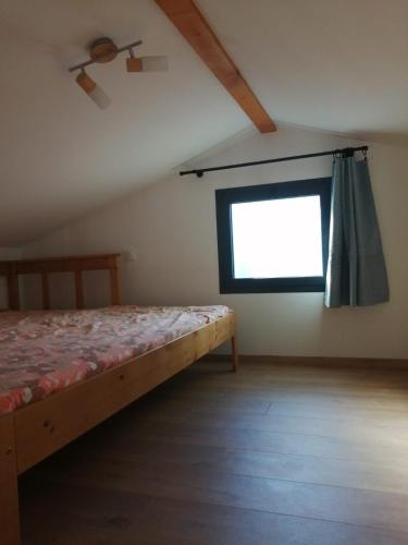 une chambre avec un lit et une fenêtre dans l'établissement un petit coin de paradis, à Anglet