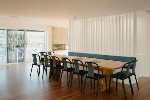 a dining room with a wooden table and chairs at Monty's House in Montville