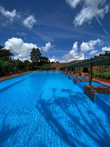 a large blue swimming pool with a blue sky at Fazenda Brotas SP in Brotas