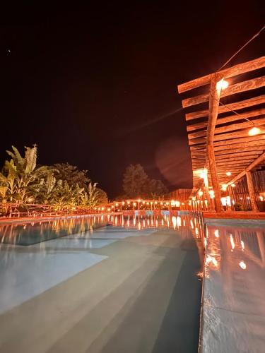a swimming pool at night with lights on it at Fazenda Brotas SP in Brotas