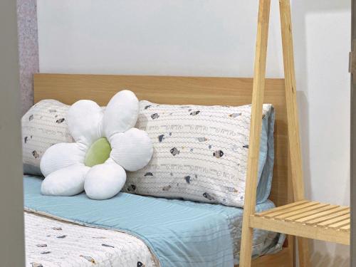 a white stuffed animal sitting on top of a bed at The Song Luxury Vung Tau - Khang Apartment 1 in Vung Tau
