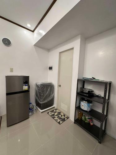 a kitchen with a refrigerator and a door in a room at Lantern Villa in Calulut