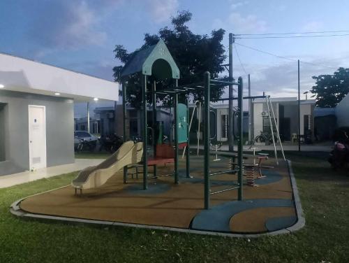 a playground with a slide in a yard at Lantern Villa in Calulut