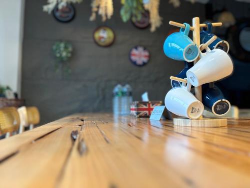 a wooden table with a cup on top of it at Villa Ten - Swing screw in Guilin