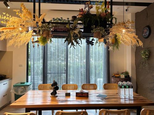a dining room with a table and a large window at Villa Ten - Swing screw in Guilin