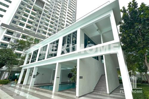 a large white building with stairs in front of a tall building at FREE Streaming Services-Designed Studio Home at Cybersquare, Cyberjaya by Flexihome-MY in Cyberjaya