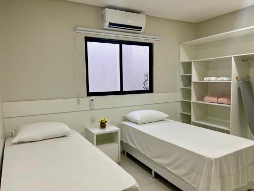 Postel nebo postele na pokoji v ubytování FLAT's TAVARES 201