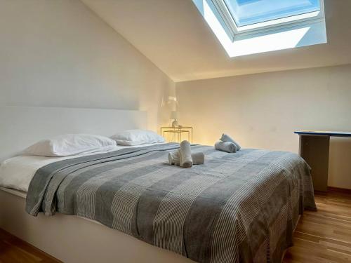 a bedroom with a bed with two stuffed animals on it at Milena Apartment Opatija in Volosko