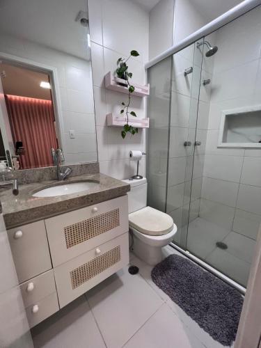 a bathroom with a toilet and a glass shower at Apartamento para COP30 com vista para a baía in Belém