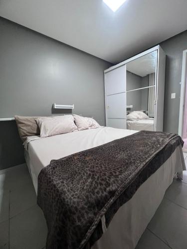 a bedroom with a large bed with a large mirror at Apartamento para COP30 com vista para a baía in Belém