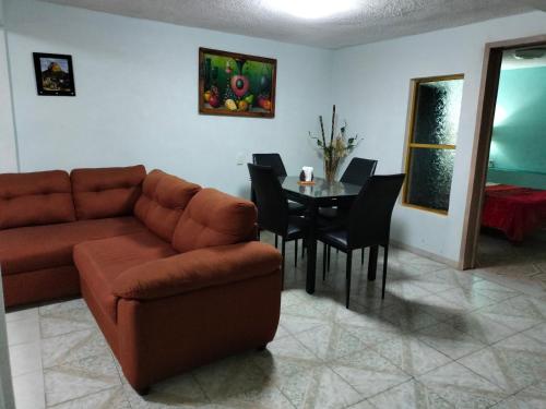 a living room with a couch and a table at Departamento San Francisco. 4 personas in Zacatlán