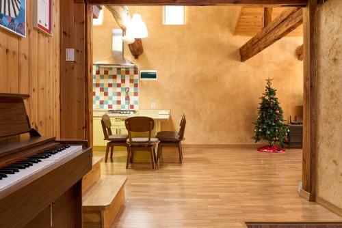 a living room with a piano and a christmas tree at Stay Yangyang The Kkotjam in Yangyang