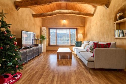 a living room with a christmas tree and a couch at Stay Yangyang The Kkotjam in Yangyang