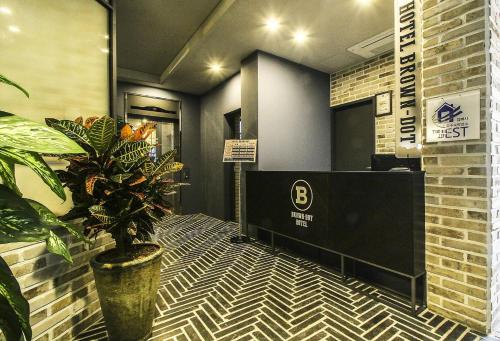 a lobby with a desk and a potted plant at Jangyu Brown Dot Hotel Water Park Branch in Gimhae