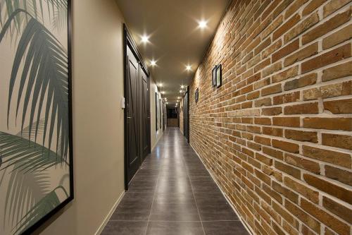 a corridor of an alley with a brick wall at Jangyu Brown Dot Hotel Water Park Branch in Gimhae