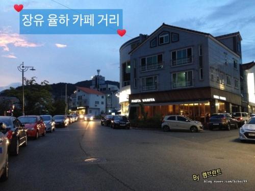 a street with cars parked in front of a building at Jangyu Brown Dot Hotel Water Park Branch in Gimhae
