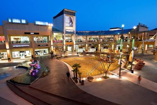 a shopping center with a mall with people in it at Jangyu Brown Dot Hotel Water Park Branch in Gimhae