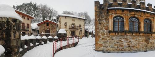 a snow covered street with buildings and a fence at Batzarki in Avellaneda