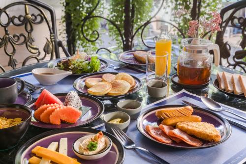 a table topped with plates of food and drinks at Skye Hotel Bangkok in Bangkok